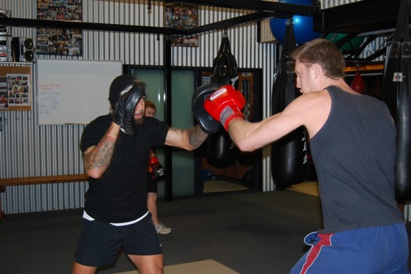 James 'Jock' Emerson (right) with coach Hemi Niha trying out pad work techniques following his win